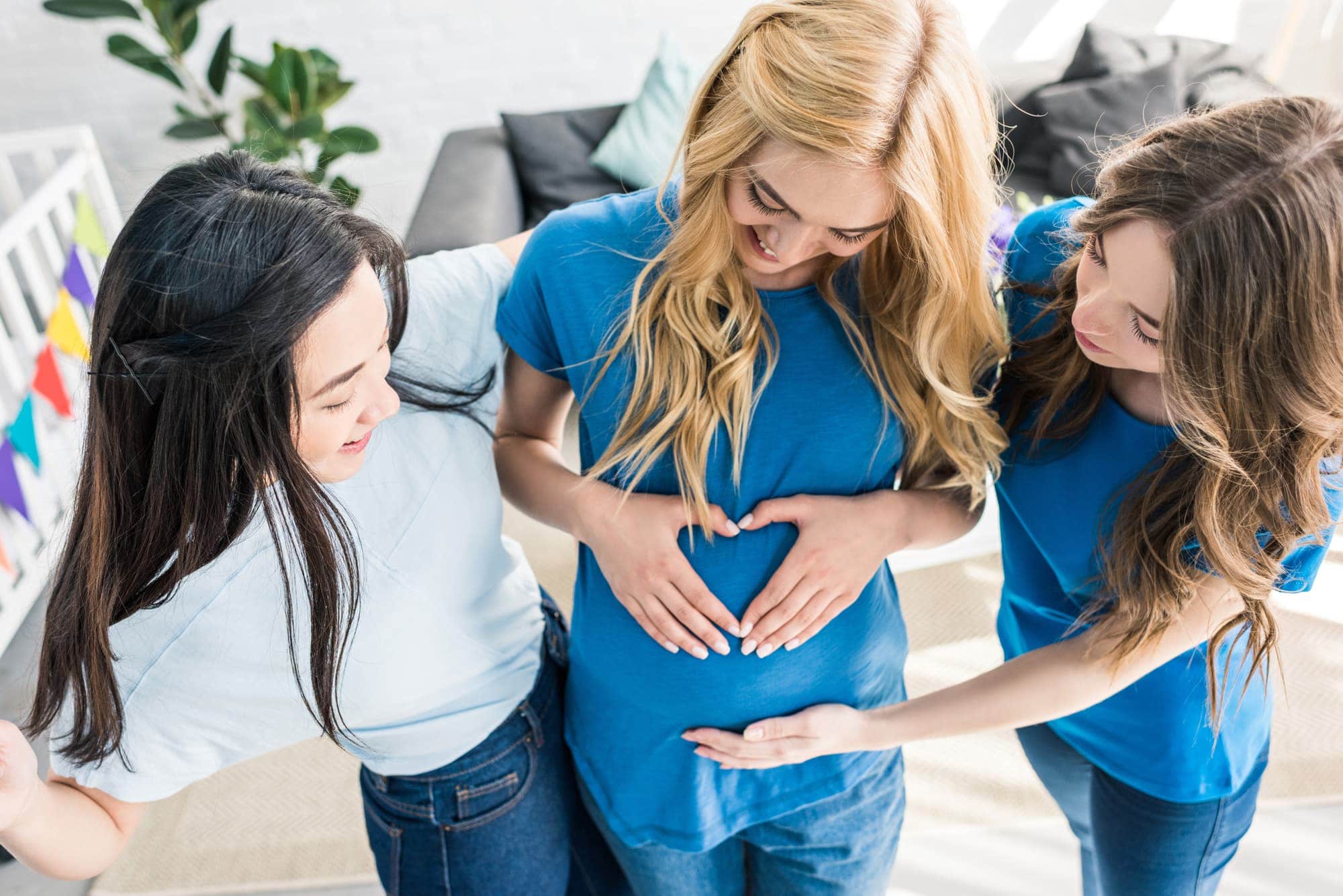 webbabyshower pregnant mom and friends holding her belly