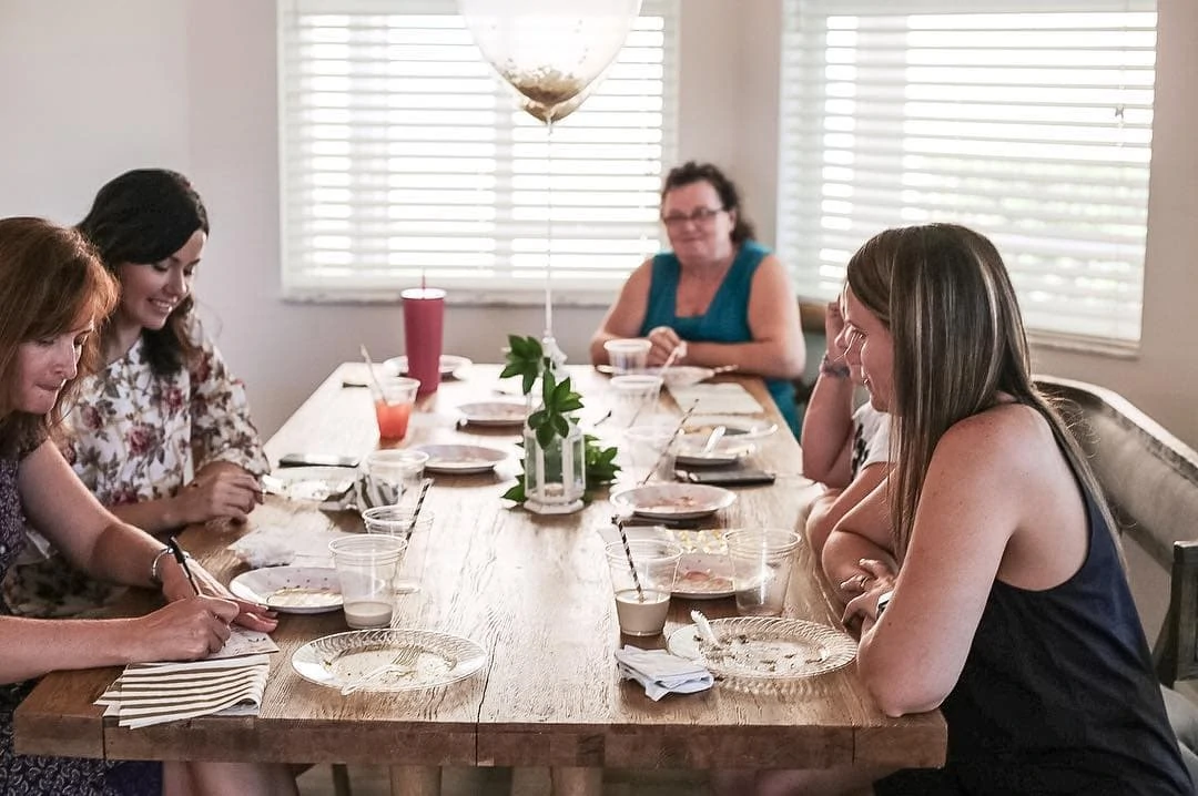 webbabyshower image from insta baby shower guests chatting and playing games