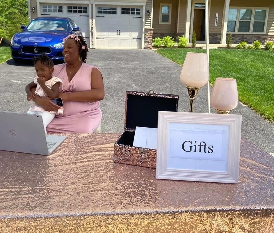 webbabyshower mother waiting for guests to drop gifts