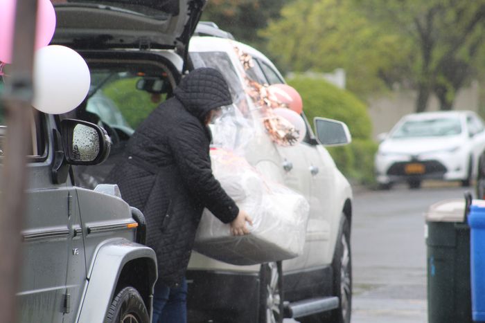 WebBabyShower guest dropping gifts in rain during drive by baby shower