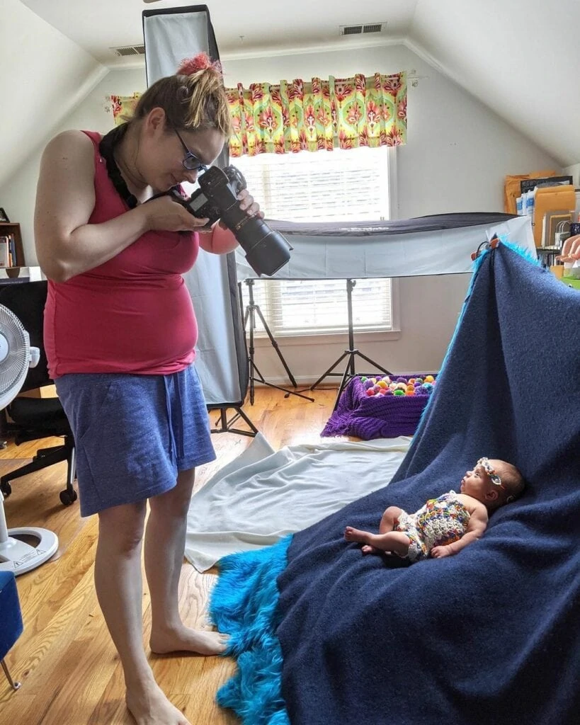 webbabyshower mom taking photo of her baby at home