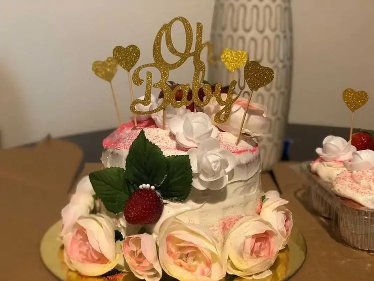 husband throws a baby shower cake