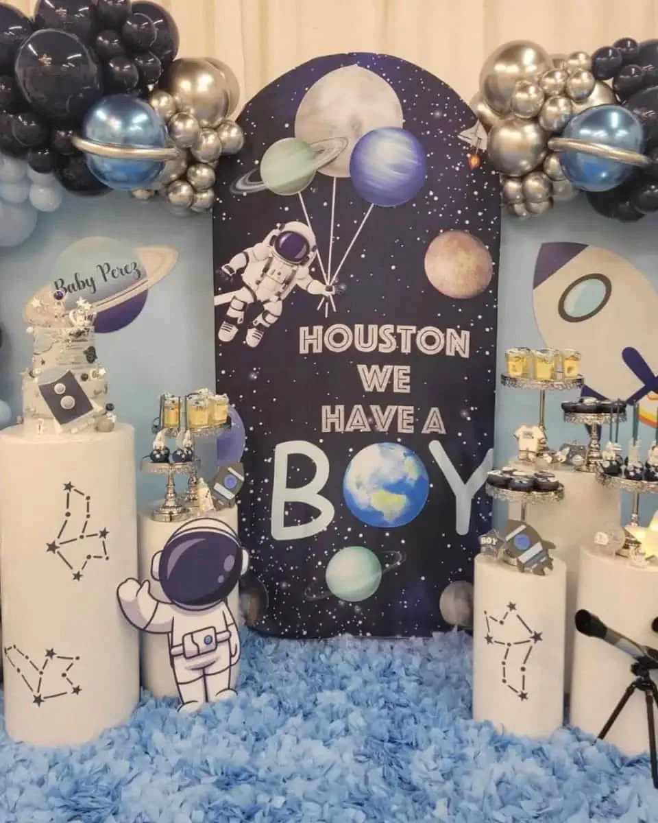 Themed baby shower decoration with astronaut and planets.