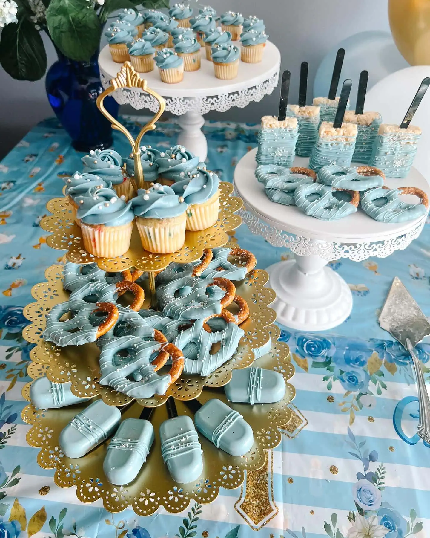 Delicious blue cupcakes, cookies, and cake pops for baby shower celebration.