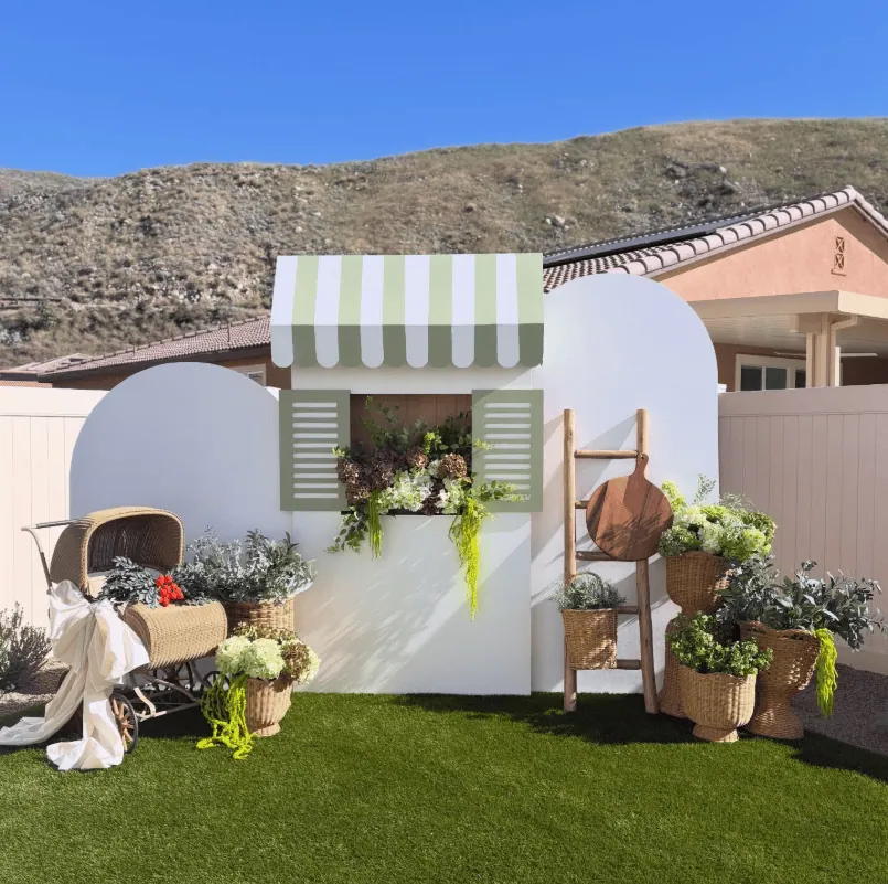 Beautiful garden party baby shower scene with floral arrangements and outdoor decor.