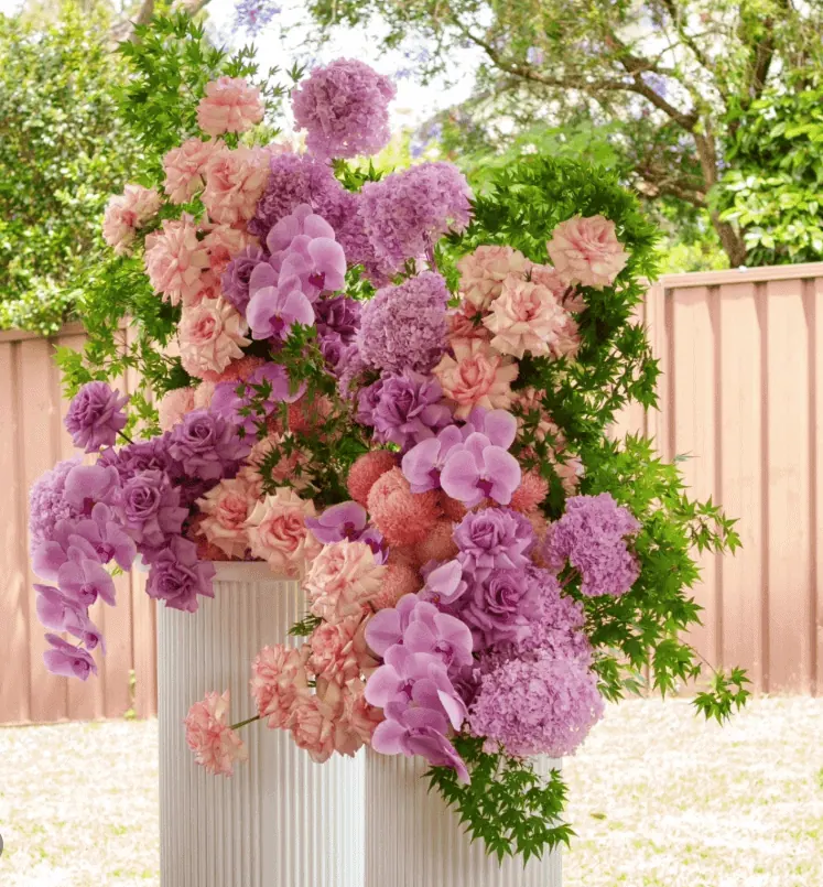 Beautiful pink and purple flower centerpiece for baby shower.