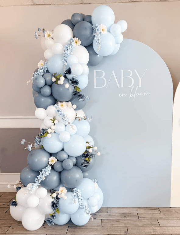Elegant blue and white balloon arch for baby shower decor.