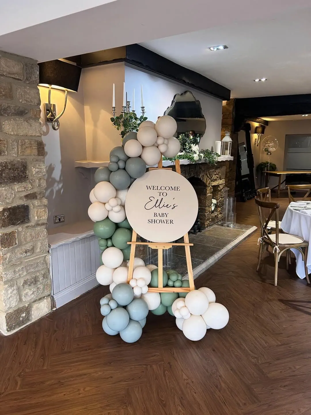 Balloon arrangement with welcome sign for baby shower celebration.